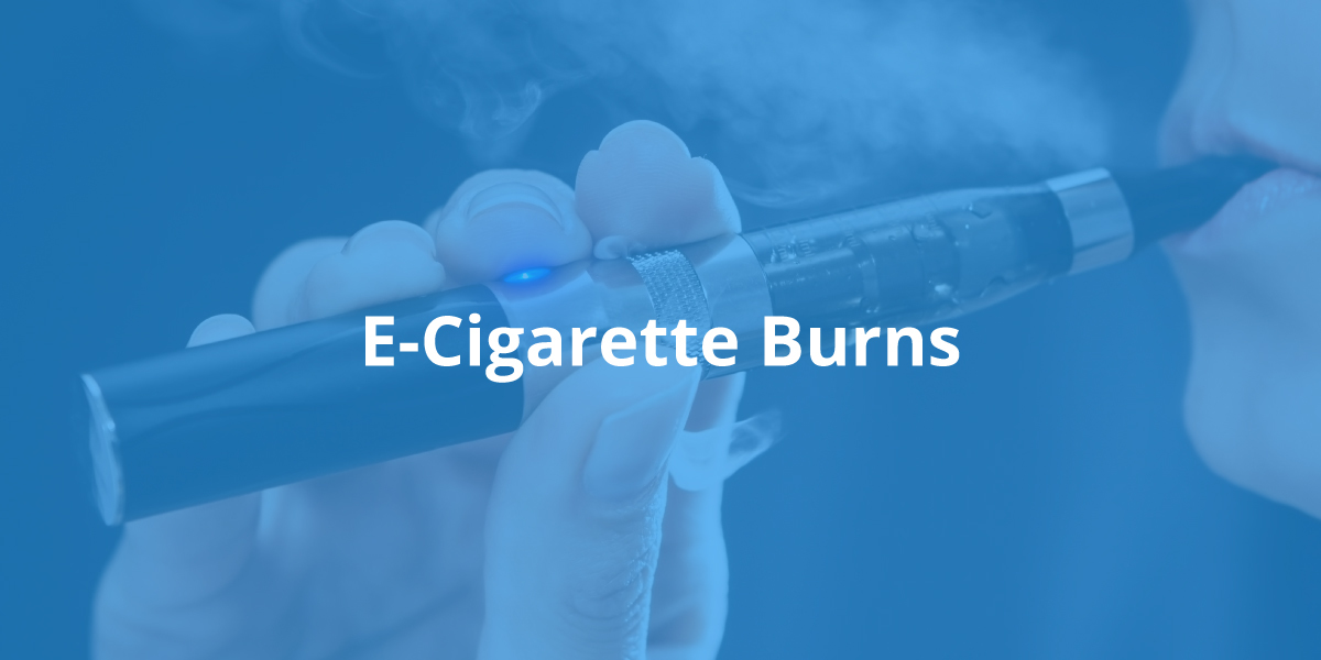 Closeup of a hand holding a smoking e-cigarette being held up to a woman's lips, tinted blue, with the words "E-Cigarette Burns" in white font in the middle.