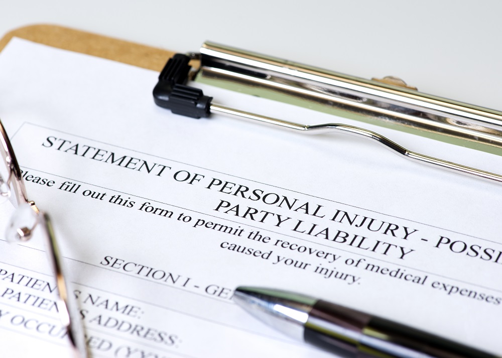 A black pen on top of a clipboard with a form titled STATMENT OF PERSONAL INJURY - PARTY LIABILITY, representing how to file a personal injury lawsuit in Philadelphia.