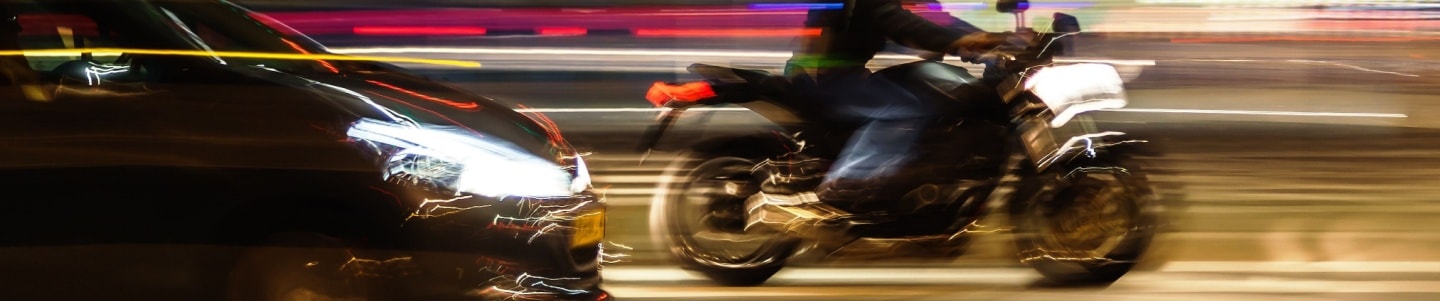 An image showing a motorcycle rider with a shorter stopping distance than is recommended for safe braking distance.