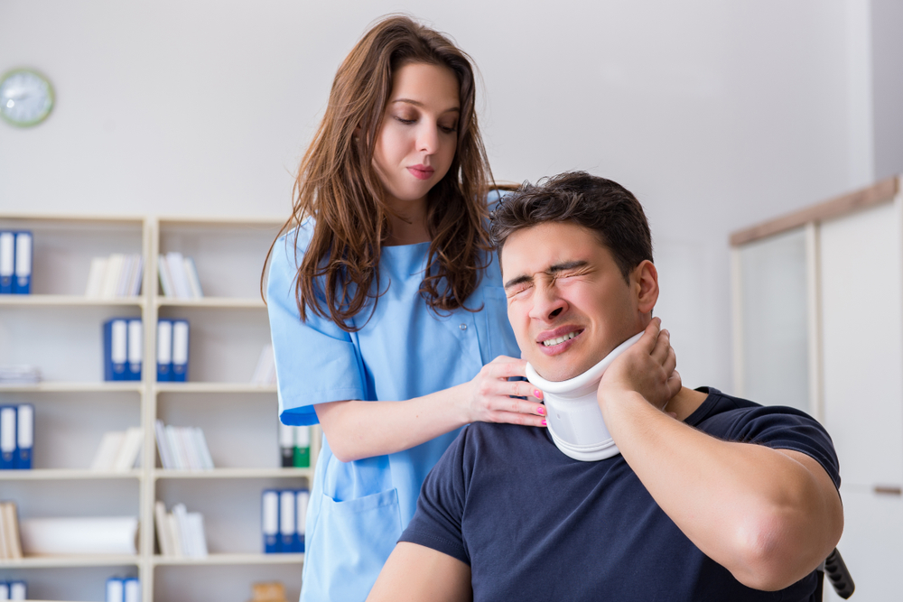 Car accident victim receiving physical therapy treatment for neck and back injuries