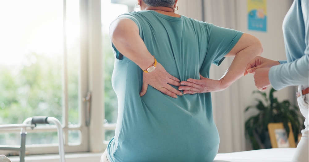 Patient discussing chronic neck and back pain treatment following accident injuries Patient discussing chronic neck and back pain treatment following accident injuries