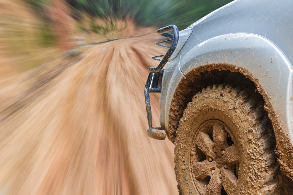 car-speeding-on-a-muddy-road