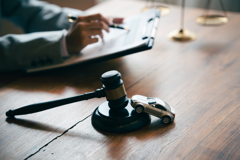 judge signing on a mud road accident claim document
